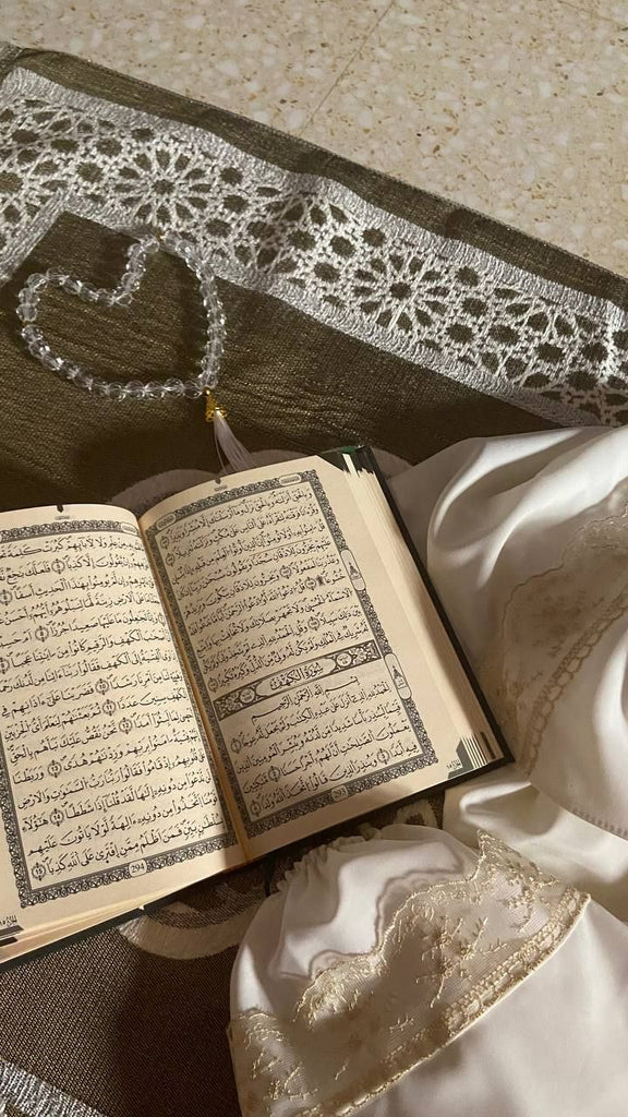 Quran and Tasbeeh shaped like a heart on top of a prayer mat