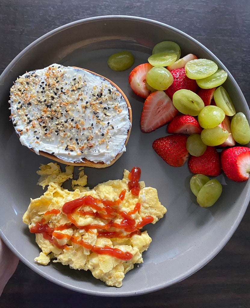 Bagel with fruit and scrambled eggs